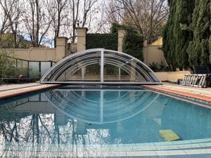 Medium-profile pool enclosure installed in a residential backyard